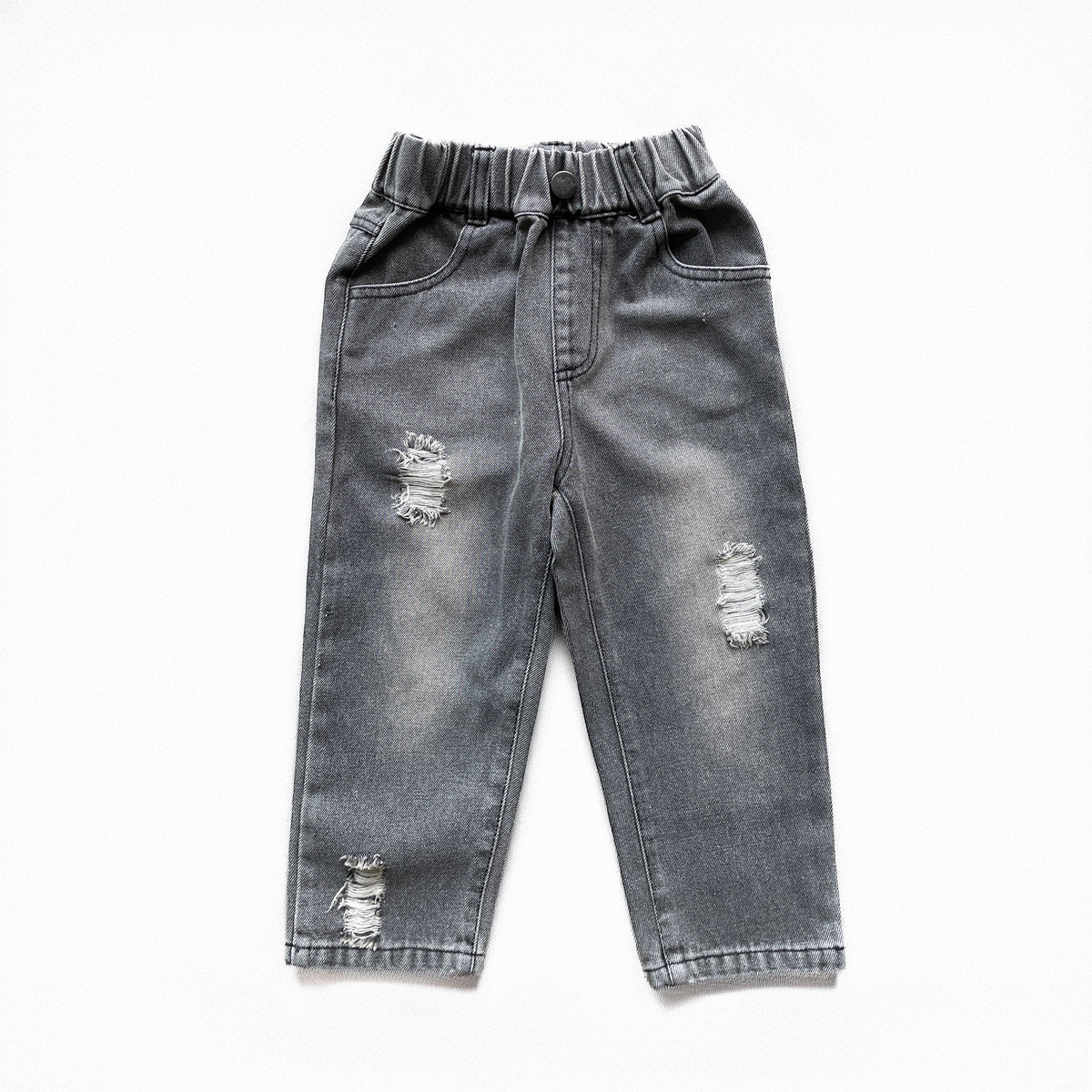 A pair of toddler's gray washed denim jeans with an elastic waistband and distressed rips on both legs, laid flat on a white background.
